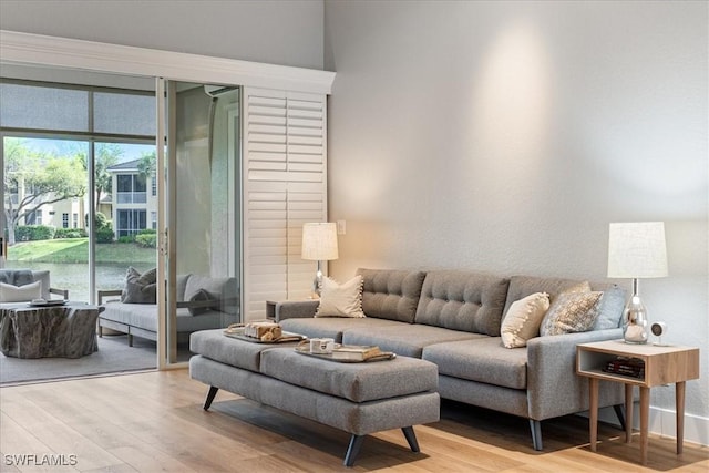 living room with a water view and wood finished floors