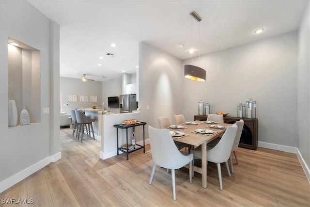 dining area featuring baseboards, recessed lighting, and light wood-style floors