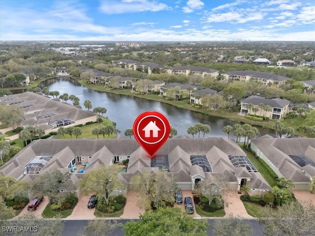 drone / aerial view featuring a water view and a residential view