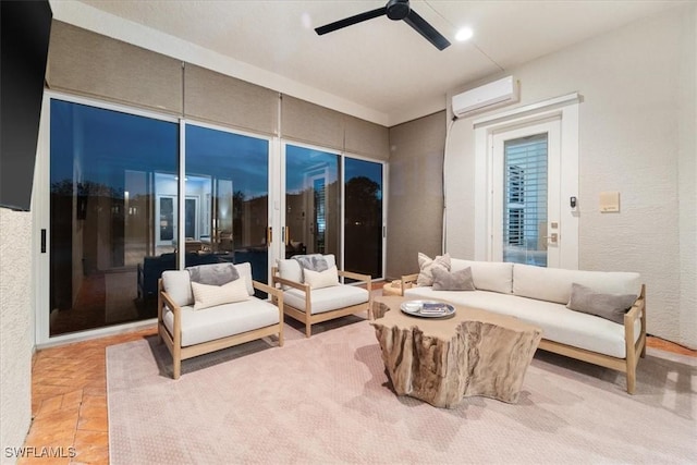 living area featuring ceiling fan, an AC wall unit, and a textured wall