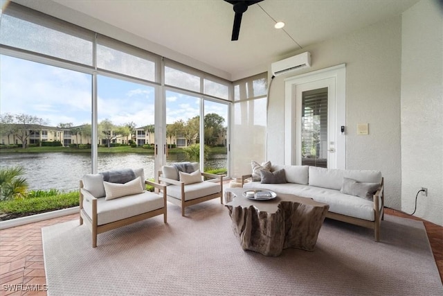 sunroom / solarium featuring a water view and a wall mounted AC