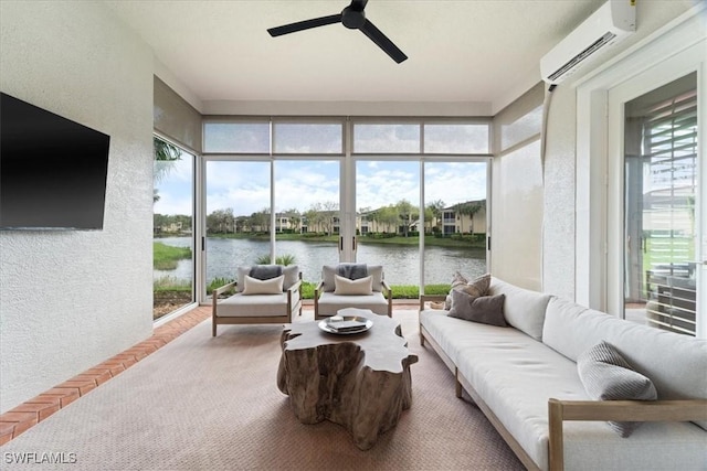 sunroom featuring a wealth of natural light, a wall mounted air conditioner, and a water view