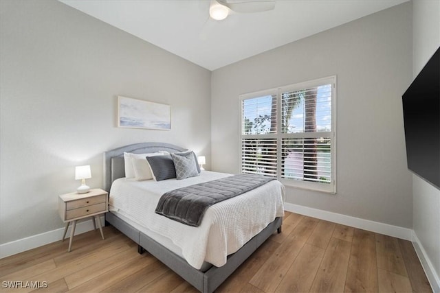 bedroom featuring baseboards, ceiling fan, and hardwood / wood-style floors