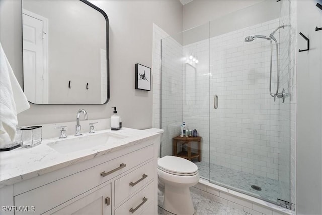 full bathroom featuring vanity, a shower stall, and toilet