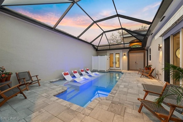 outdoor pool featuring french doors and a patio area