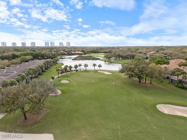 birds eye view of property featuring view of golf course, a water view, and a city view