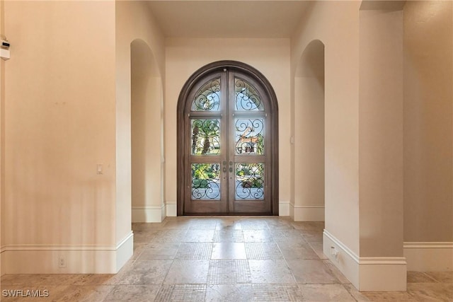 view of exterior entry featuring french doors