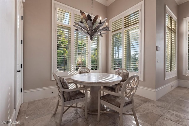 dining room featuring a chandelier and baseboards