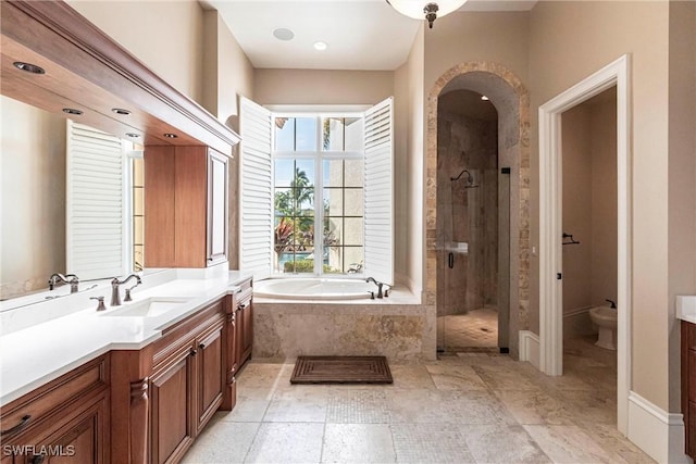 bathroom with a garden tub, a shower stall, and vanity