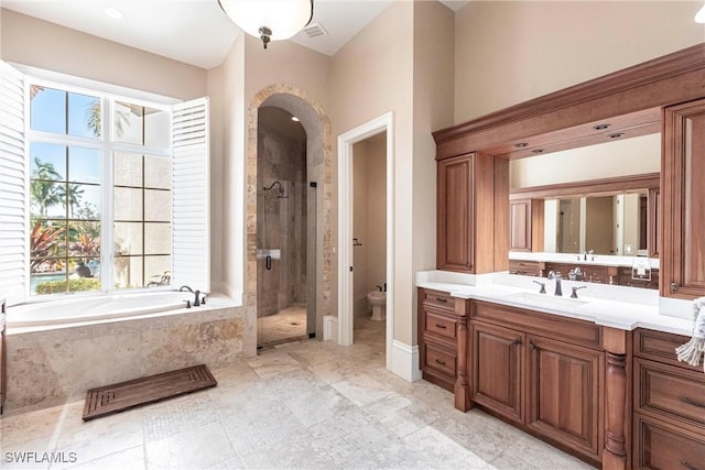 bathroom featuring a garden tub, toilet, visible vents, vanity, and a stall shower