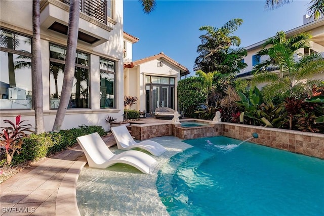 view of swimming pool featuring a pool with connected hot tub