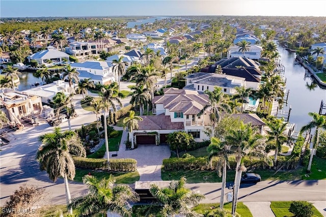 birds eye view of property with a water view and a residential view