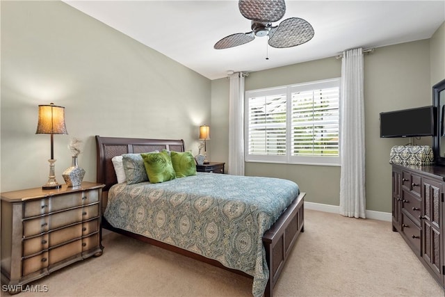 bedroom featuring baseboards, a ceiling fan, and light colored carpet