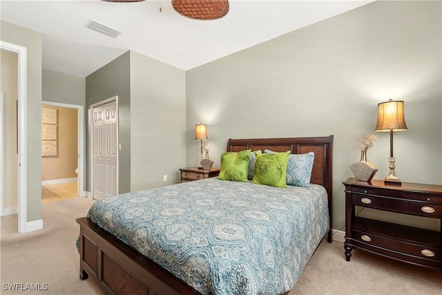 bedroom featuring a closet, carpet, visible vents, and baseboards