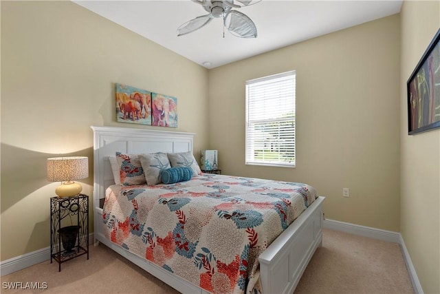 bedroom featuring a ceiling fan, light carpet, and baseboards