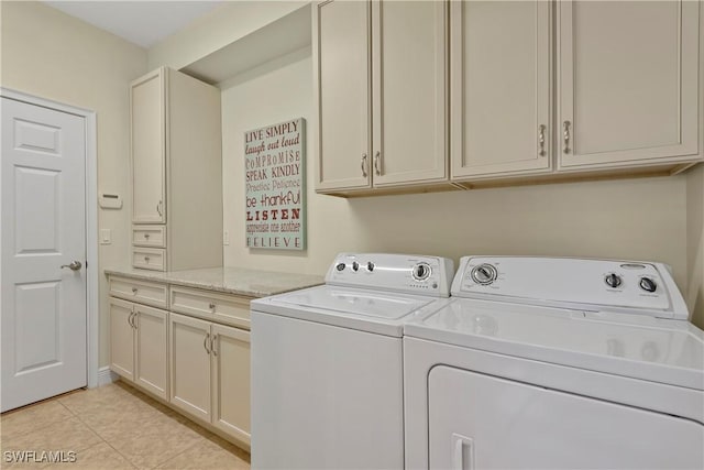 laundry room featuring cabinet space, washer and clothes dryer, and light tile patterned flooring