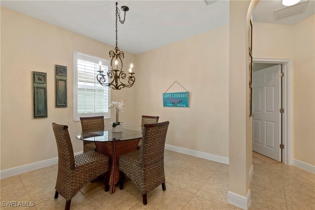 dining area with light tile patterned floors, visible vents, and baseboards