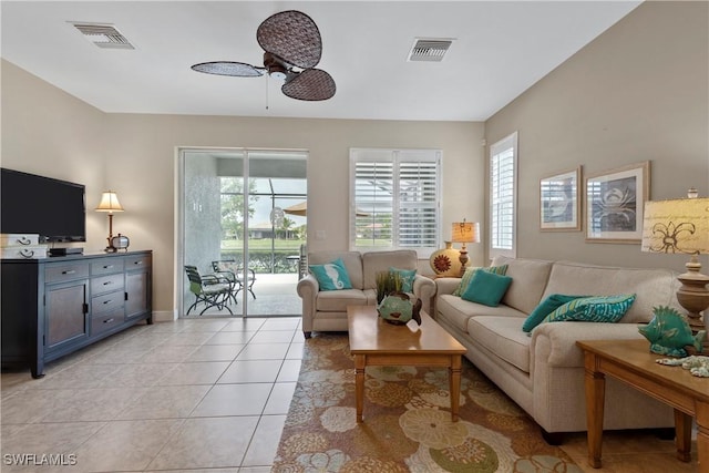 living area with light tile patterned floors, plenty of natural light, and visible vents