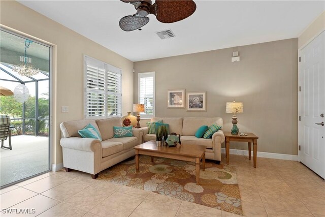 living area featuring visible vents, a ceiling fan, and light tile patterned flooring