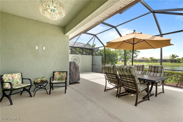 view of patio with outdoor dining area and a lanai