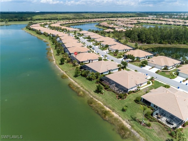 birds eye view of property with a water view and a residential view