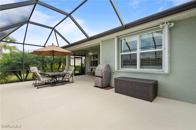 view of patio / terrace with a lanai, outdoor dining space, and area for grilling