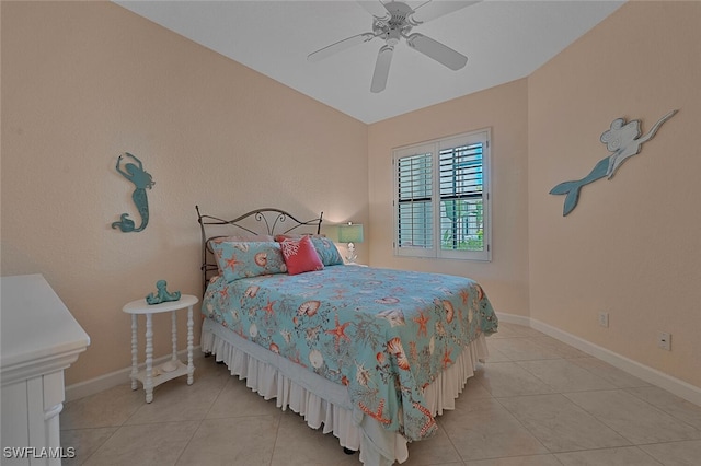 bedroom with ceiling fan, baseboards, and light tile patterned flooring