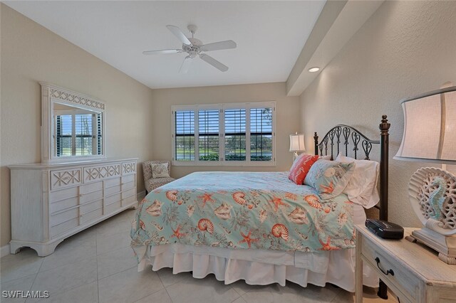 tiled bedroom featuring multiple windows and ceiling fan