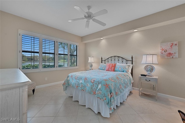 bedroom with light tile patterned floors, ceiling fan, and baseboards