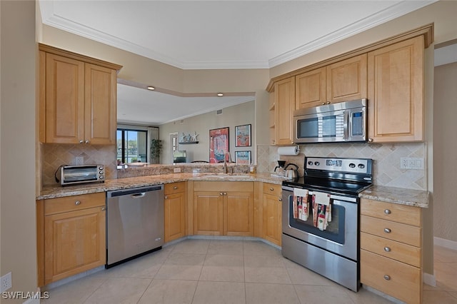 kitchen with a toaster, stainless steel appliances, a sink, light stone countertops, and crown molding