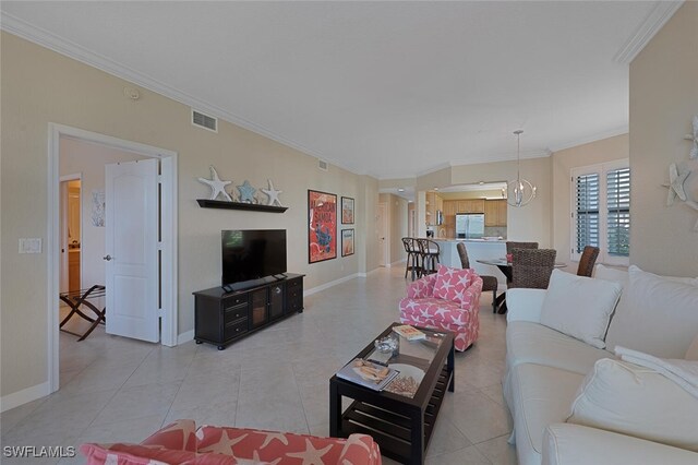 living room with a chandelier, light tile patterned floors, visible vents, baseboards, and crown molding