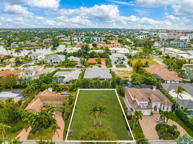 birds eye view of property featuring a water view and a residential view