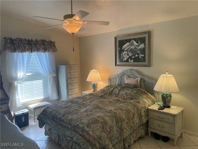 bedroom with light tile patterned floors, baseboards, and a ceiling fan