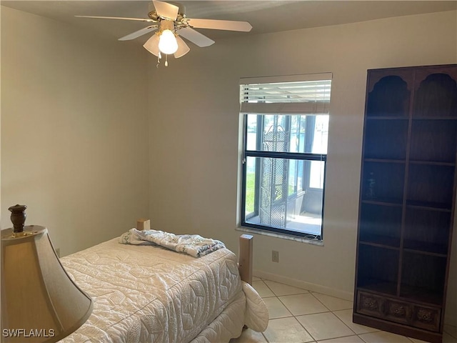 bedroom featuring ceiling fan, baseboards, and light tile patterned floors