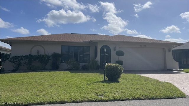 ranch-style house featuring a front lawn, decorative driveway, an attached garage, and stucco siding