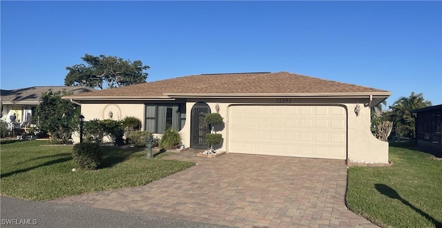 single story home with an attached garage, a front yard, decorative driveway, and stucco siding