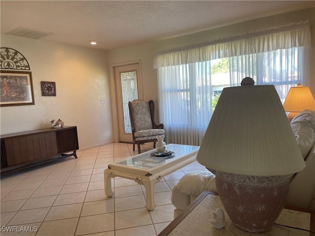 living room featuring light tile patterned floors and visible vents