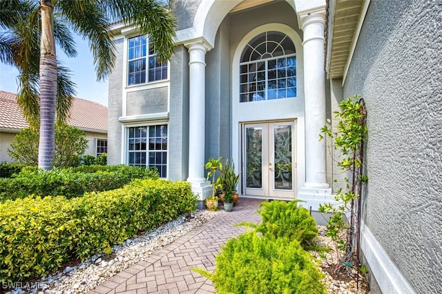 property entrance featuring french doors and stucco siding