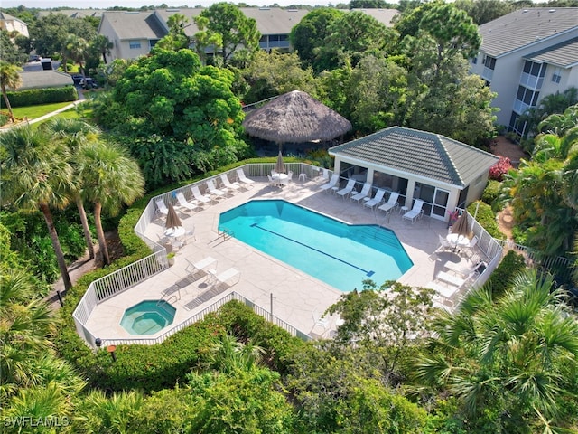 community pool featuring a patio area, fence, a community hot tub, and a gazebo