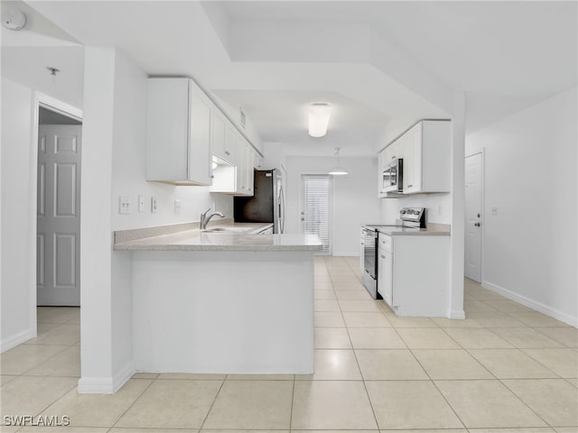 kitchen featuring appliances with stainless steel finishes, light countertops, a sink, and light tile patterned flooring