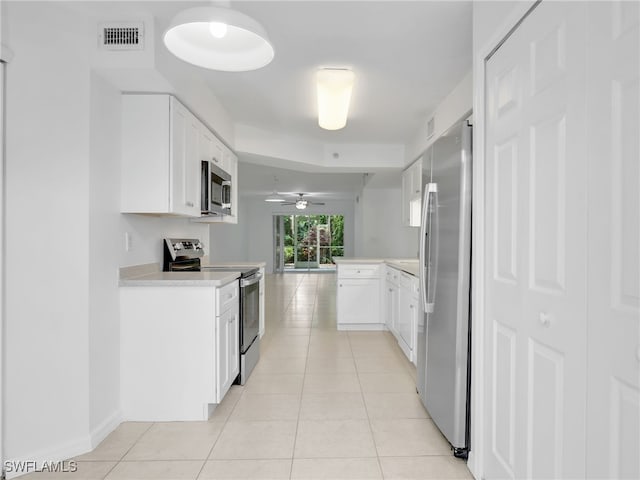 kitchen featuring stainless steel appliances, light countertops, visible vents, and light tile patterned floors