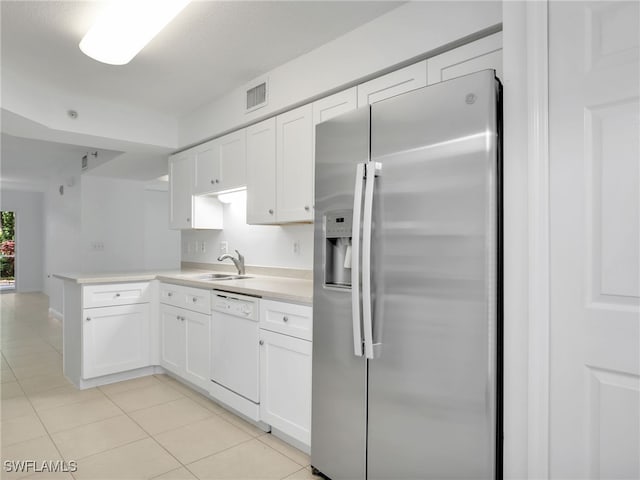 kitchen featuring visible vents, white cabinets, dishwasher, stainless steel fridge with ice dispenser, and a sink