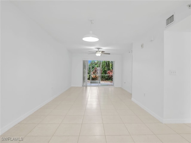 unfurnished room with visible vents, ceiling fan, baseboards, and light tile patterned floors