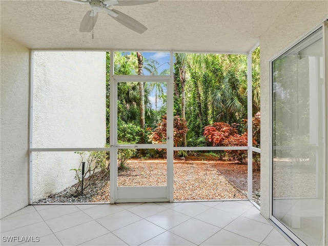 unfurnished sunroom featuring ceiling fan