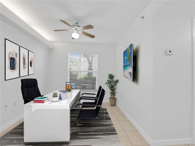 home office featuring light tile patterned floors, baseboards, and a ceiling fan