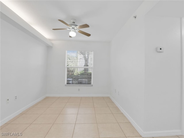 spare room with ceiling fan, baseboards, and tile patterned floors