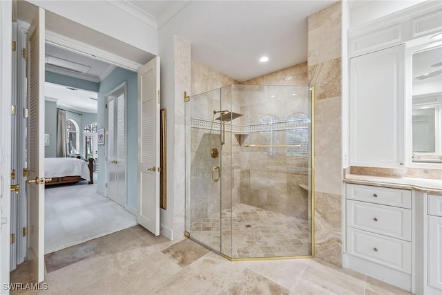 bathroom featuring ornamental molding, connected bathroom, a shower stall, and vanity