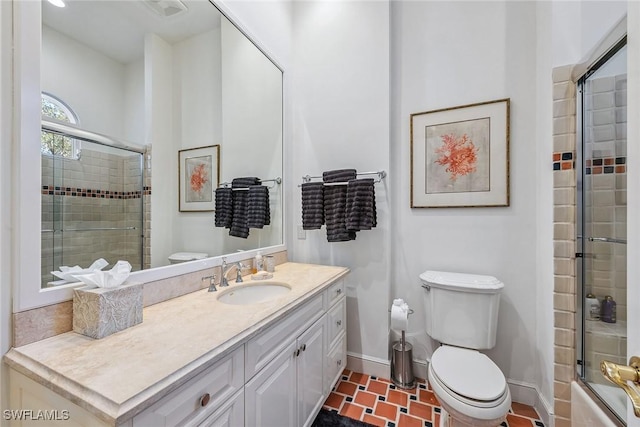 full bathroom with baseboards, vanity, and toilet