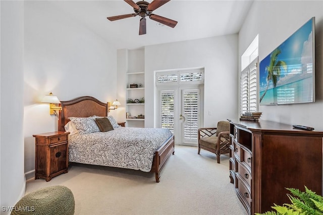 bedroom featuring ceiling fan, multiple windows, light colored carpet, and access to exterior