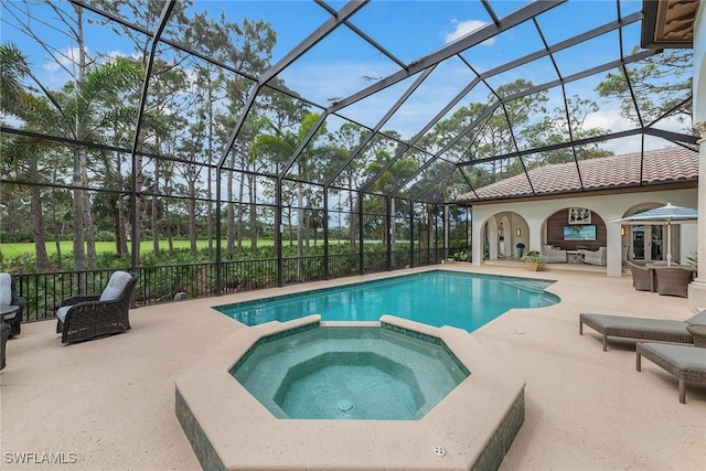 view of swimming pool with a patio area, outdoor lounge area, a lanai, and a pool with connected hot tub